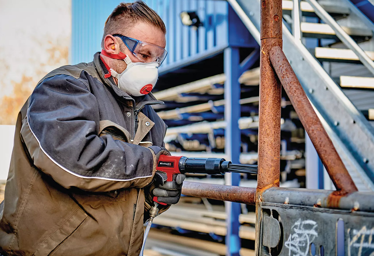 Απεικονίζεται άνδρας να χρησιμοποιεί το αεροκόπιδο σε οικοδόμημα.